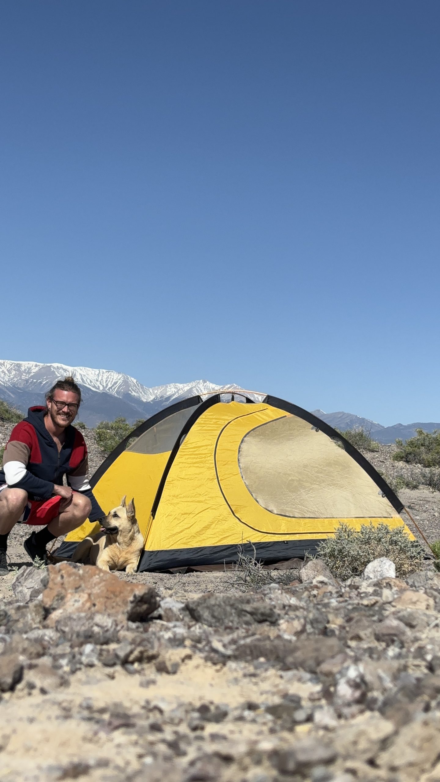 Zachary and Nova next to their tent in a desert in Nevada. 